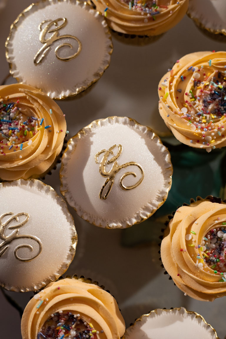 White upcakes with a personalised calligraphic G logo on them