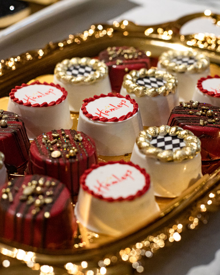 Oreo style cookies with Hamleys logo on an elegant gold tray
