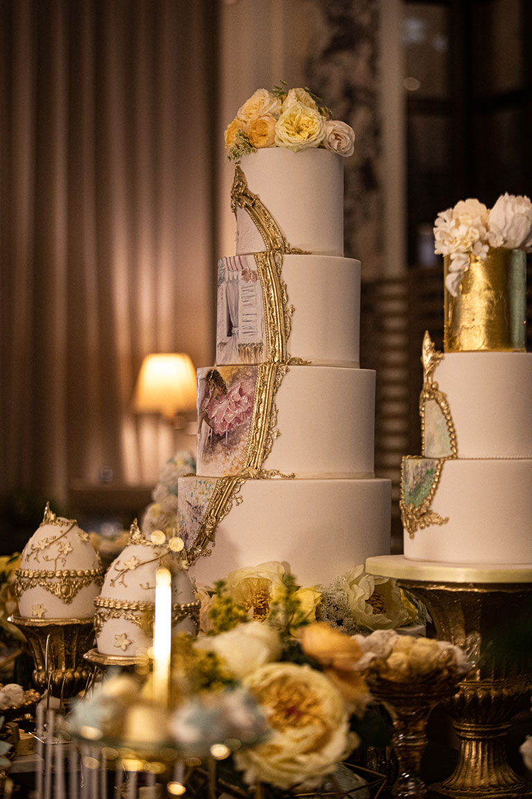 A 5 tier elegant wedding or corporate cake with a hand painted ballerina scene framed in a gold border