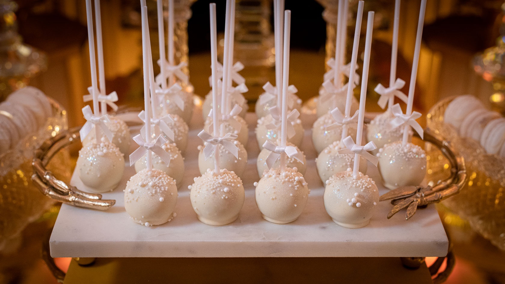 Elegant white luxury cake pops individually tied with ribbon by GC Couture