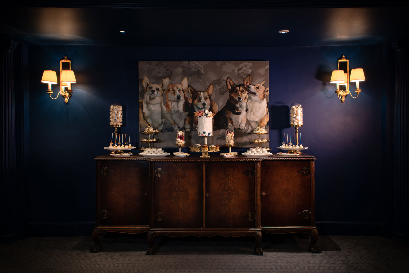 Placed in front of the magnificent portrait of the Queen’s beloved Corgis, a small bespoke Indulgence Bar&reg; by GC Couture
